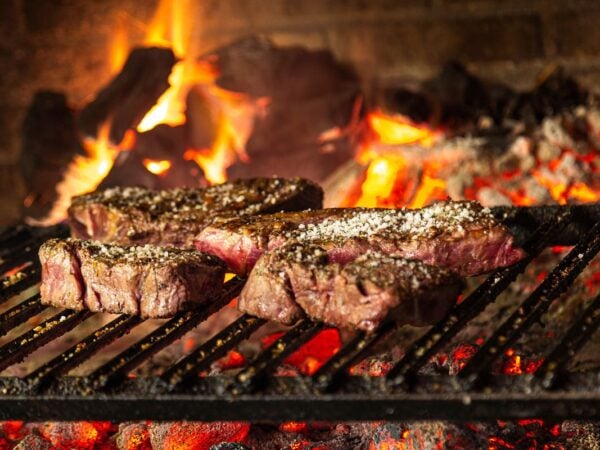 steaks on an open hearth in fulton market chicago
