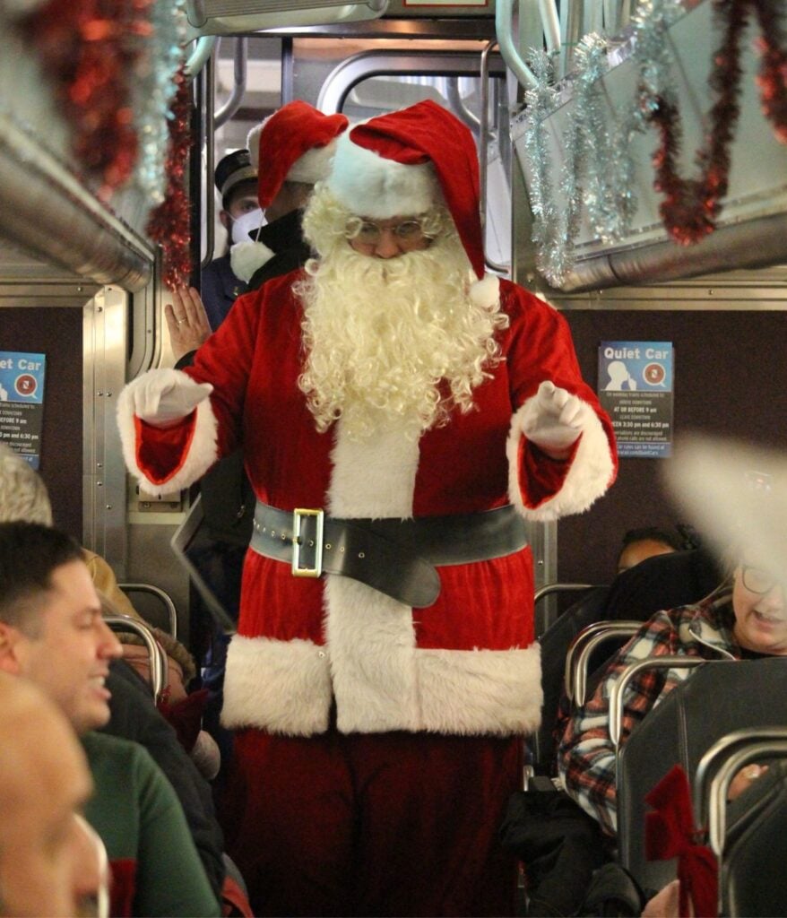 Santa greeting children on Geneva Polar Express Storytime Train in Illinois