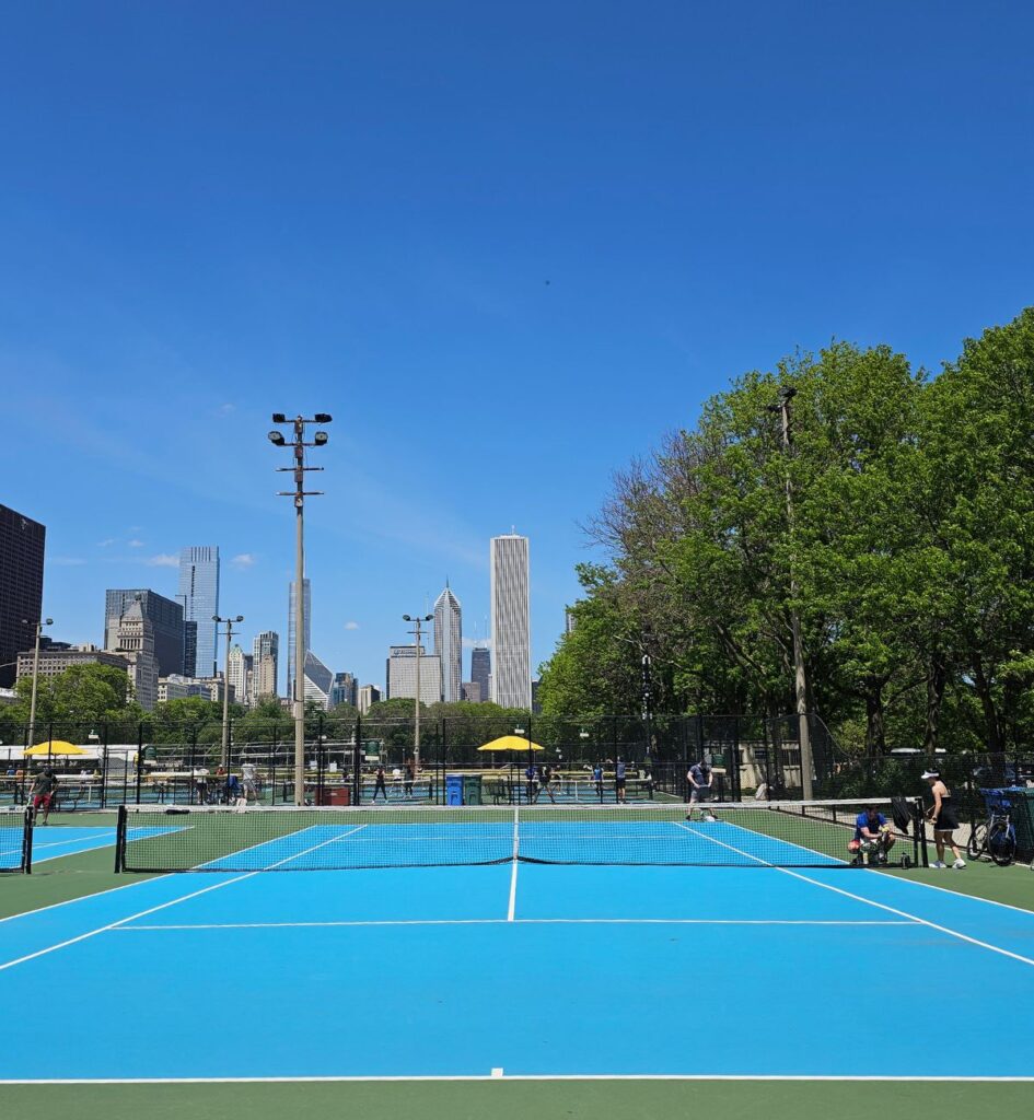Grant Park tennis courts in Chicago with players and the downtown skyline in the background