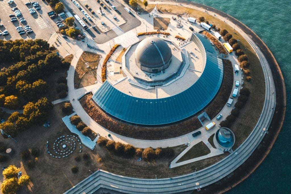 Aerial view of Adler Planetarium on Lake Michigan in Chicago with walking paths and waterfront views