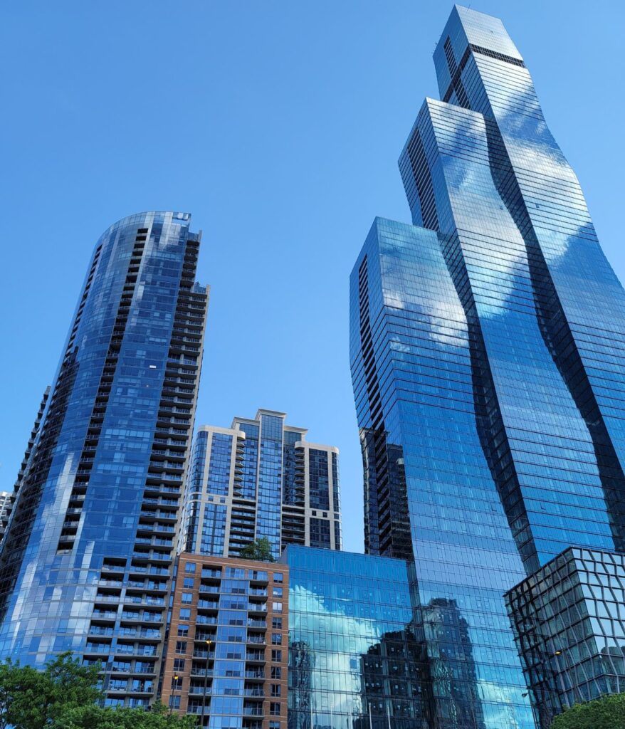 Modern Chicago skyline featuring glass skyscrapers and high-rise buildings under a blue sky