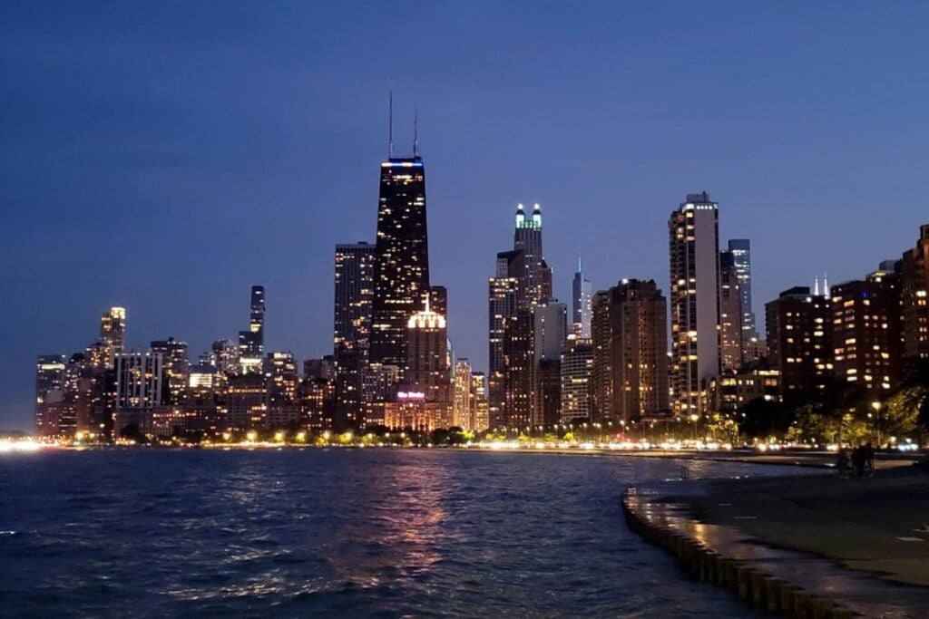 Chicago skyline at night from Lake Michigan with illuminated buildings and waterfront