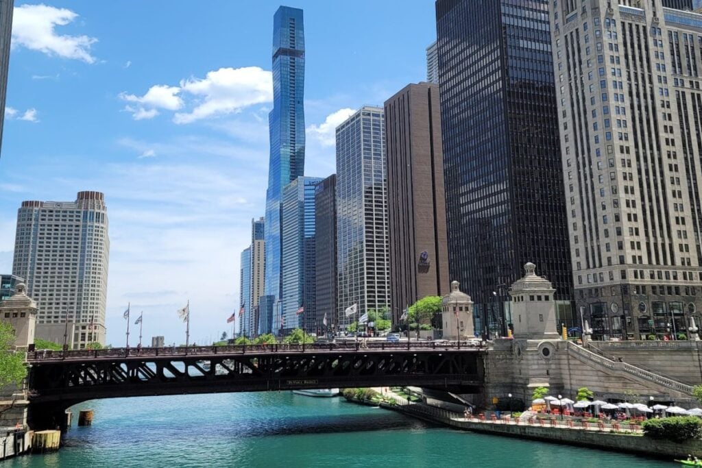 Chicago River with bridge and downtown skyline along the Chicago Riverwalk on a sunny day