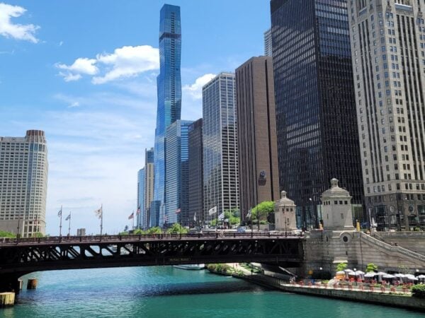 Chicago River with bridge and downtown skyline along the Chicago Riverwalk on a sunny day