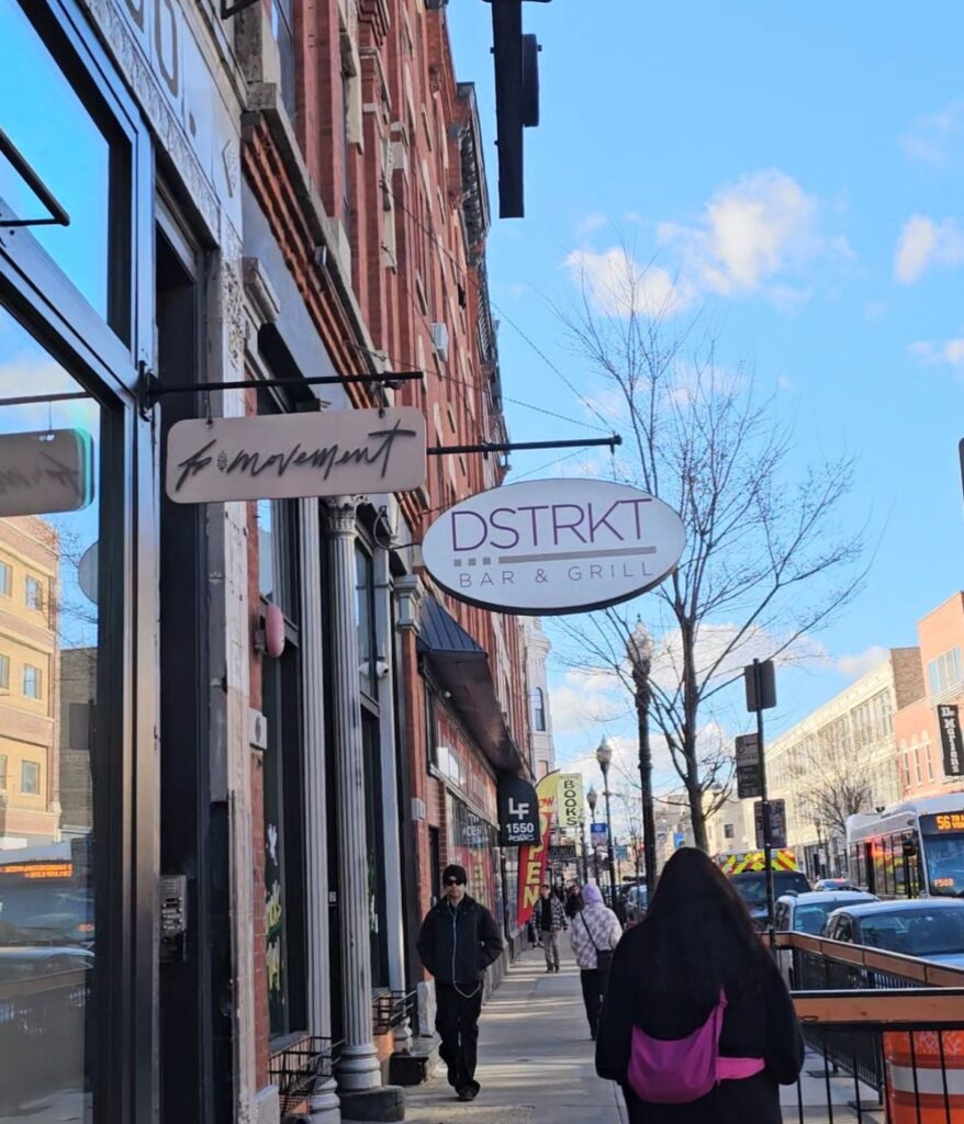 Wicker Park Chicago street with local shops, restaurants, and pedestrians walking along Milwaukee Avenue