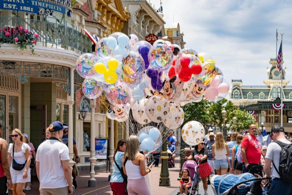 Disney character balloons for sale on Main Street USA at Magic Kingdom Walt Disney World with crowds of families
