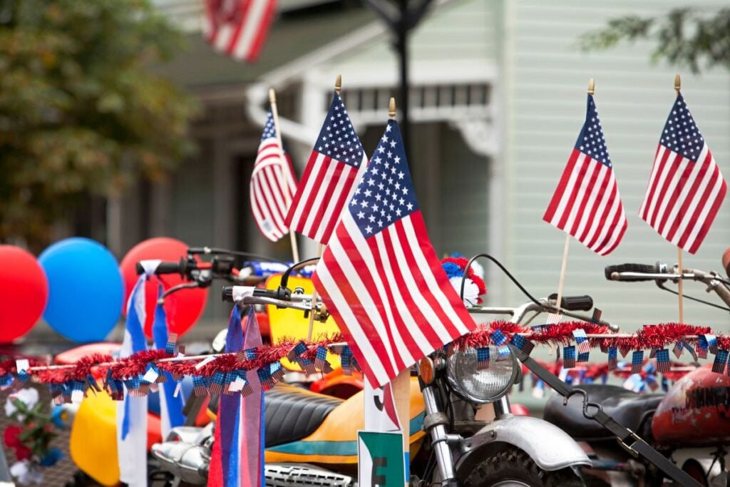 American flags and patriotic decorations displayed on bikes and parade vehicles during a Memorial Day celebration in Chicago.