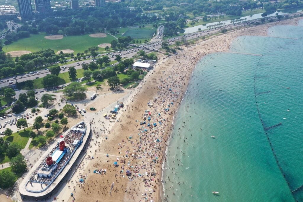Aerial view of North Avenue Beach in Chicago filled with people along Lake Michigan during Memorial Day weekend.