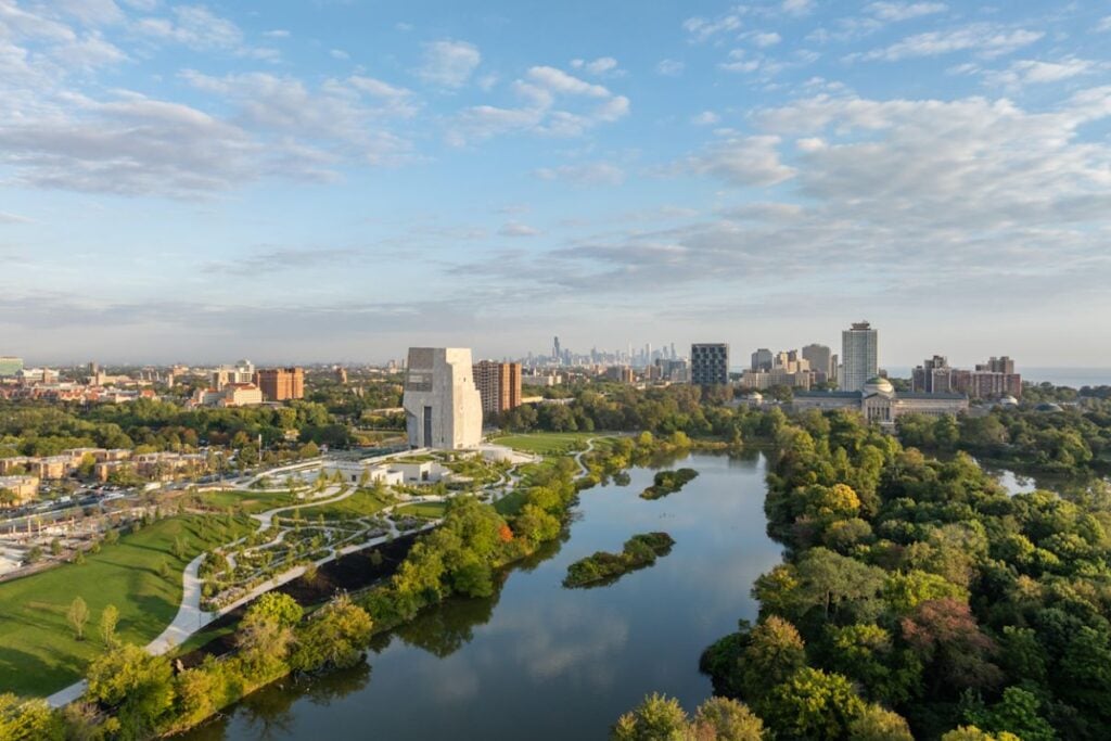 Aerial view of the Obama Presidential Center Museum Tower in Jackson Park with the Chicago skyline in the distance