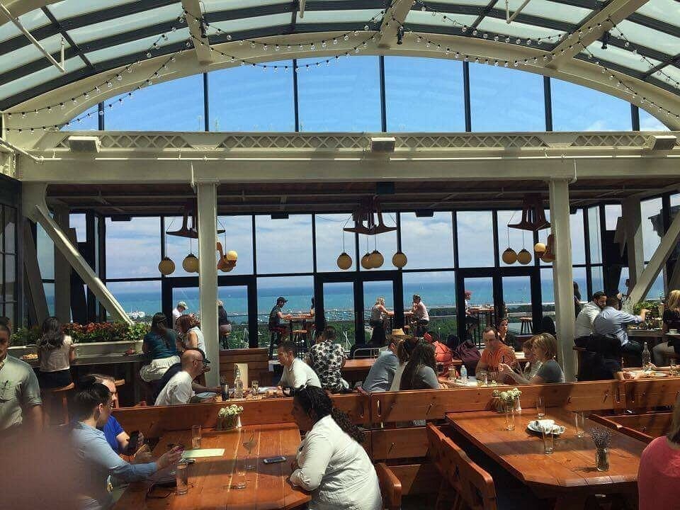 Skylit dining room at Cindy's Rooftop with Lake Michigan and skyline views through tall windows in the Loop, Chicago