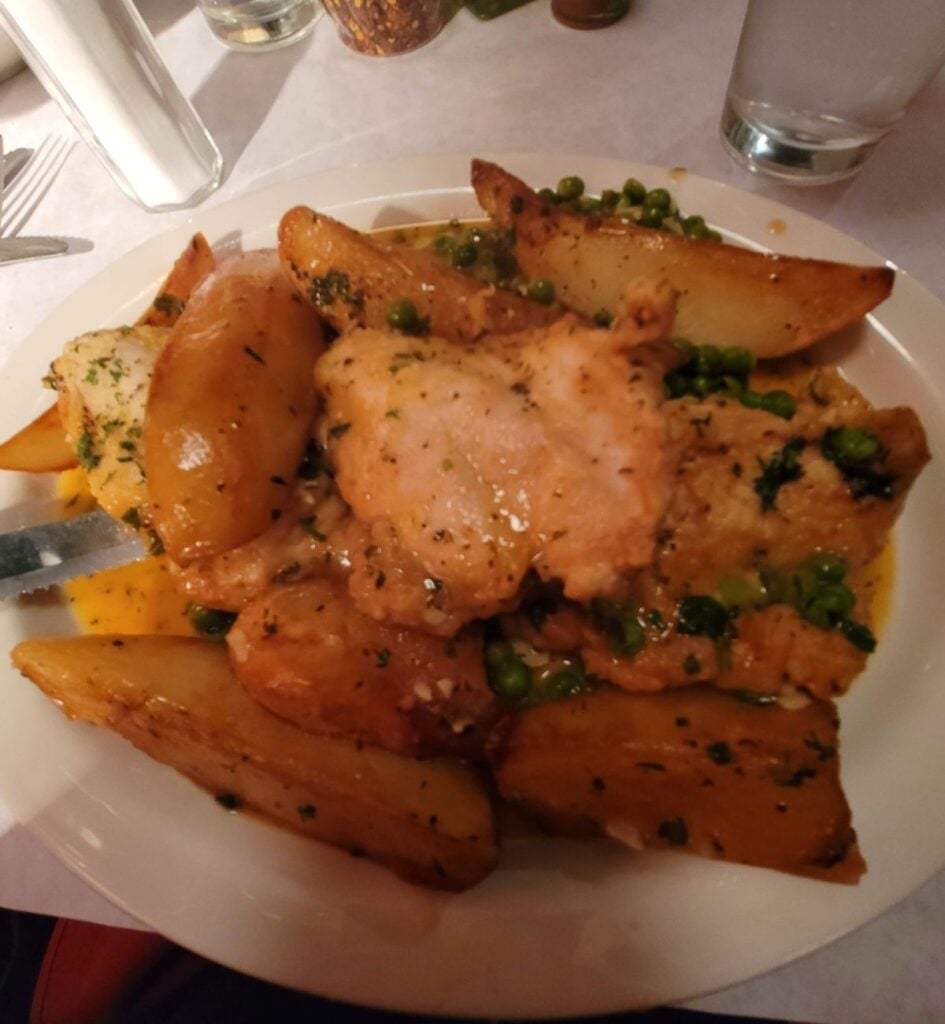 Chicken Vesuvio with roasted potato wedges and peas at La Scarola in Chicago