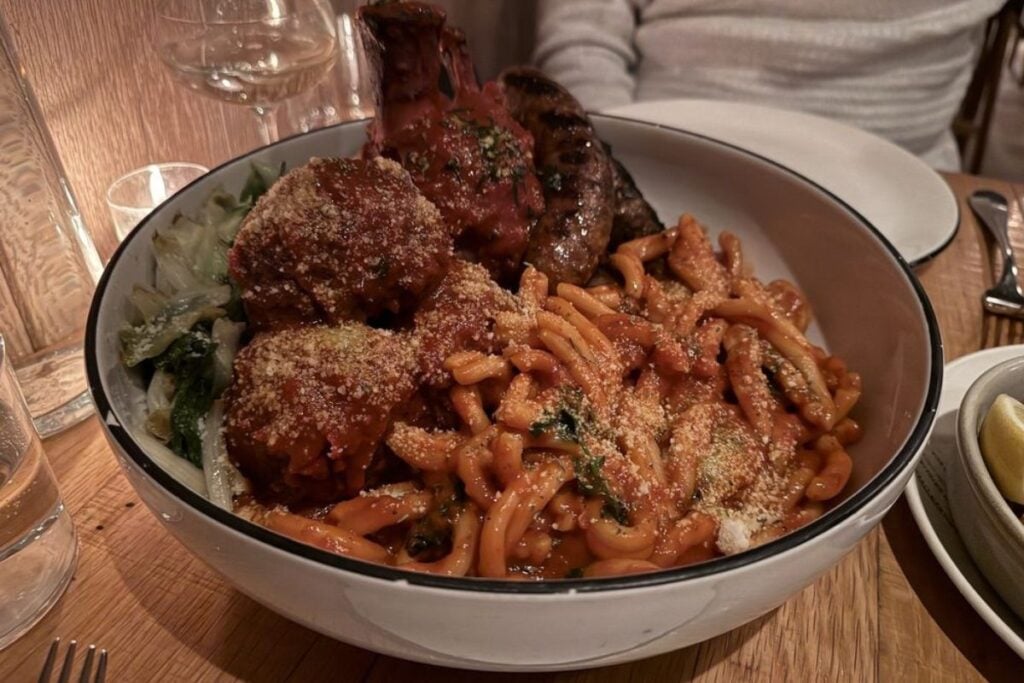 Ragù Napoletana with pasta, meatballs, and Italian sausage in red sauce at Monteverde in Chicago's West Loop
