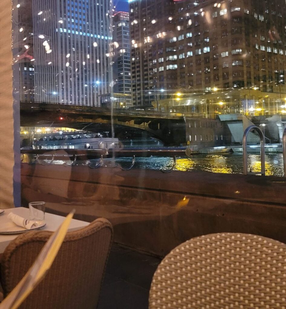 Nighttime Chicago River and skyline view from a window table at Pizzeria Portofino