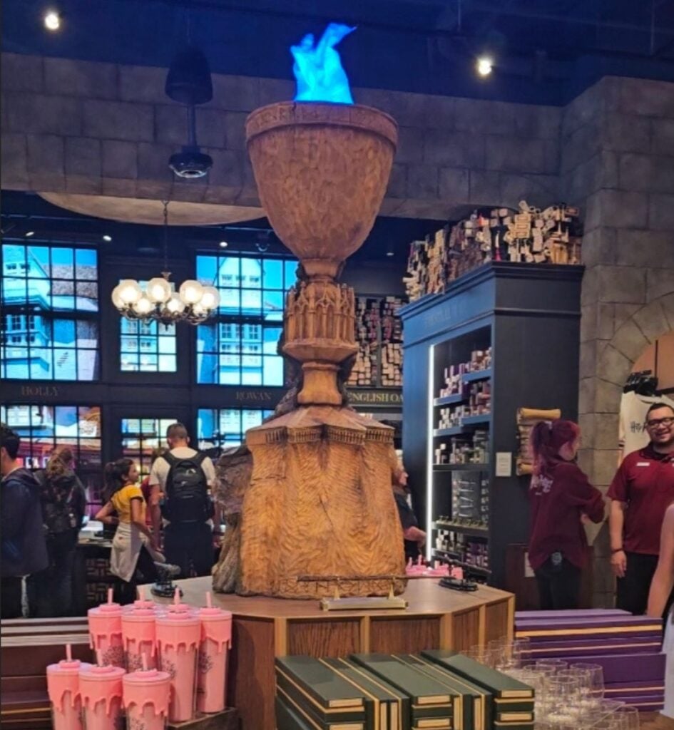Goblet of Fire display with blue flame inside the Harry Potter Shop on Michigan Avenue in Chicago, with wand displays behind it