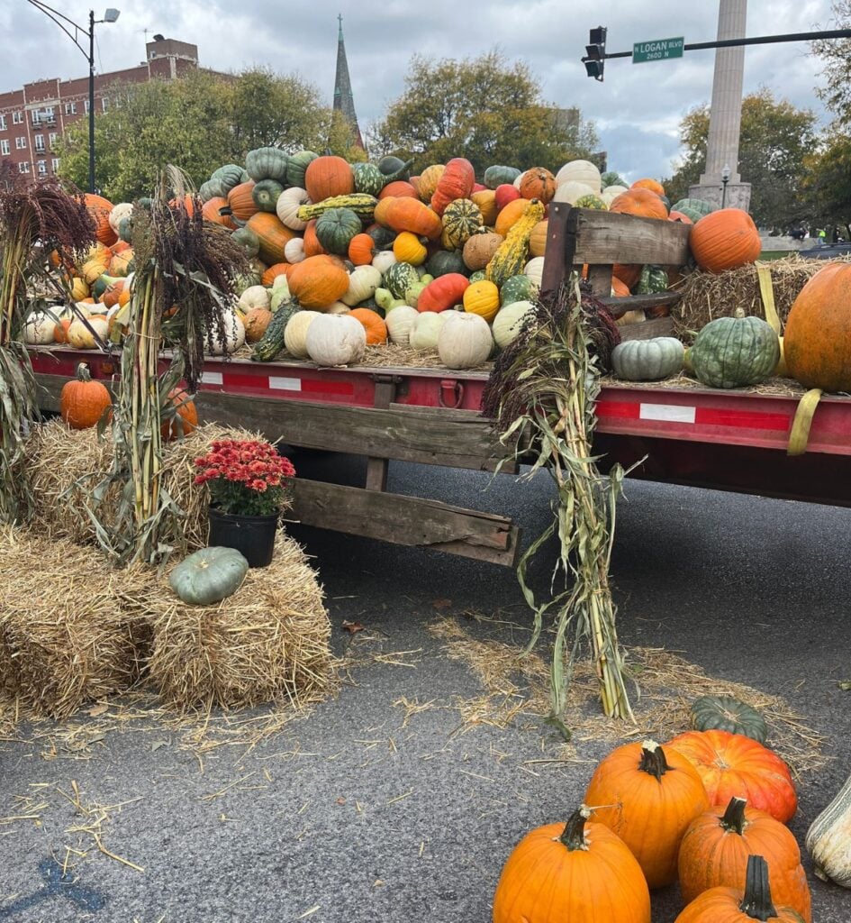 Flatbed truck piled with pumpkins, gourds and squash at the Logan Square farmers market on Logan Boulevard in Chicago