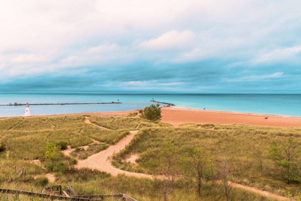 Lake Michigan shoreline at New Buffalo, Michigan with the pier lighthouse and dune grass