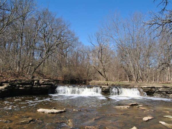 Rocky Glen waterfall spilling over limestone ledges into Sawmill Creek at Waterfall Glen Forest Preserve in Darien